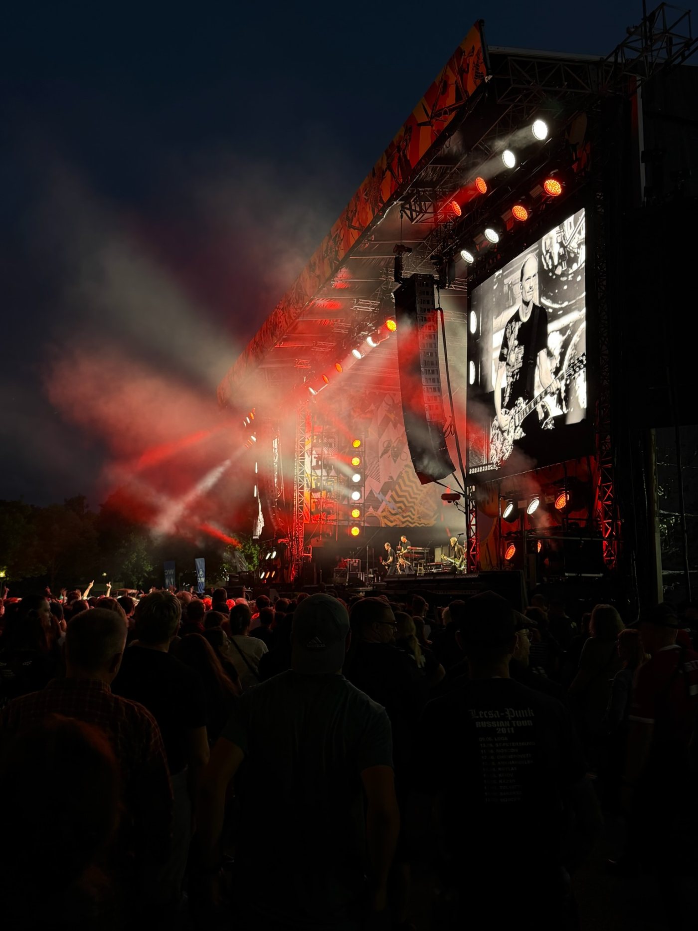 Open-air festival stage at night with crowd